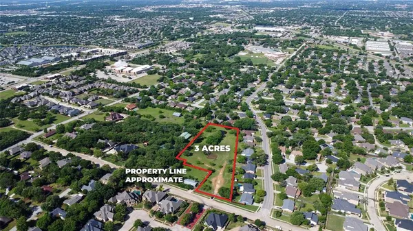 an aerial view of residential houses with city view