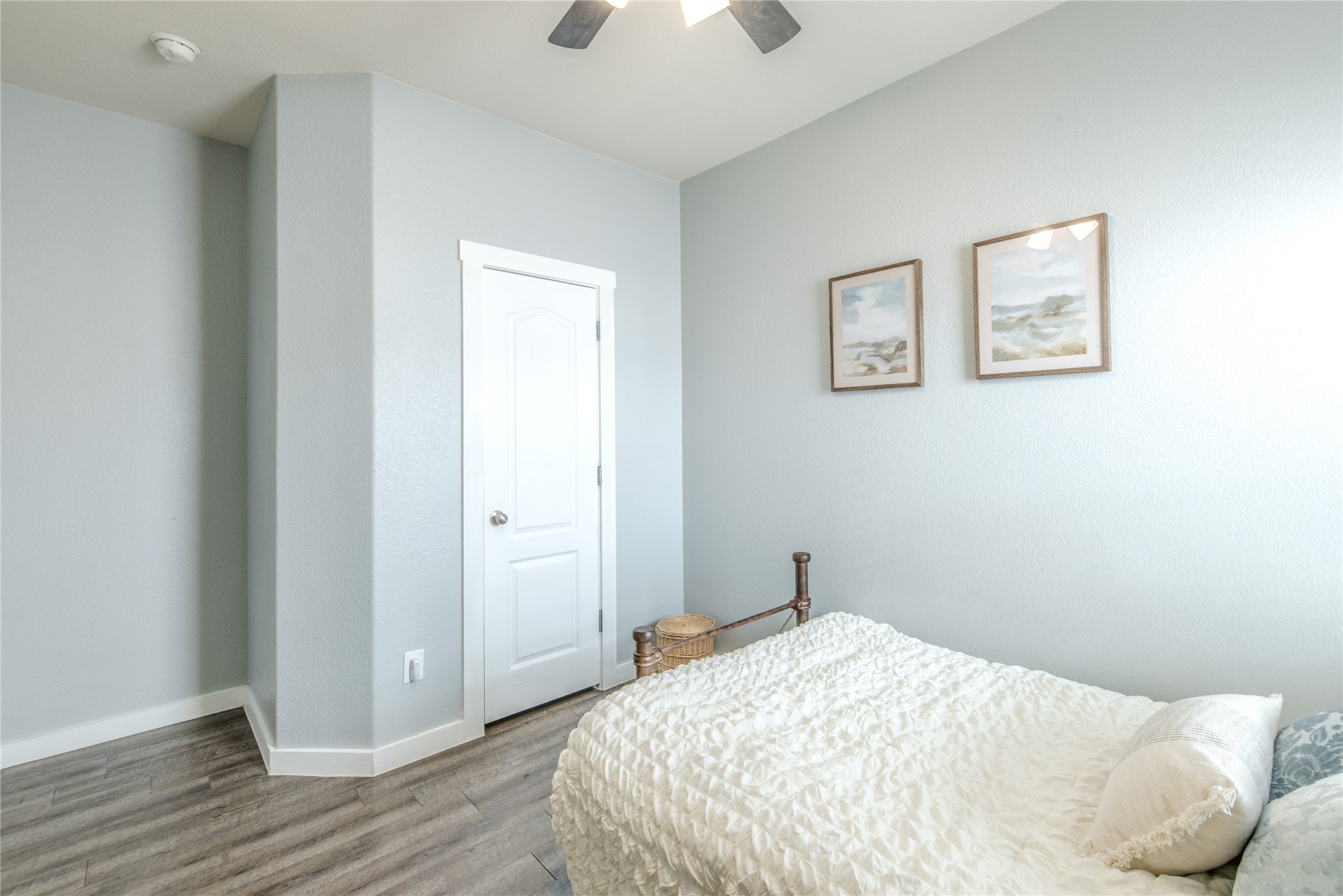 1089 Hot Spring Valley Buda, TX 78610 - Photo 14 of 26 Plank flooring and high ceilings complement this serene bedroom space.