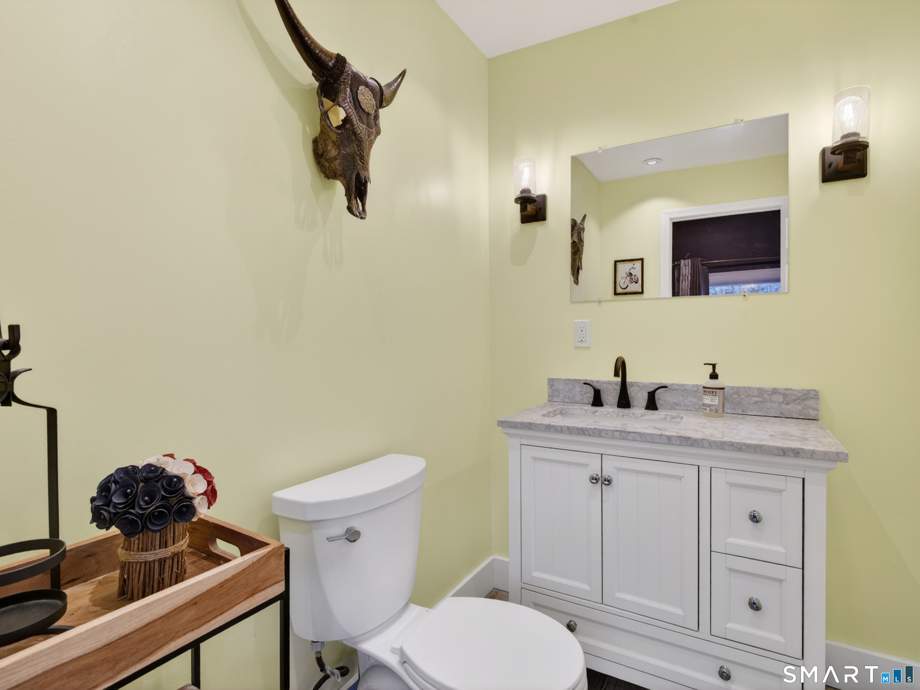 76 Starr Hill Road Groton, CT 06340 - Photo 16 of 40 a bathroom with a toilet sink and mirror