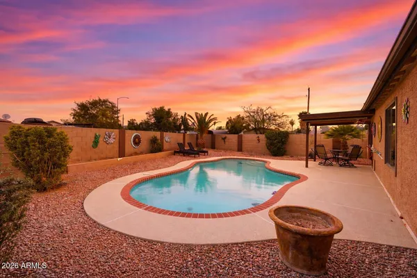 a view of a swimming pool with a yard