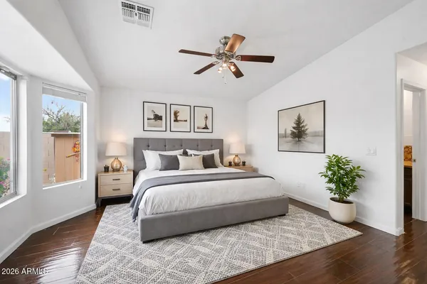 a bedroom with a large bed and a window