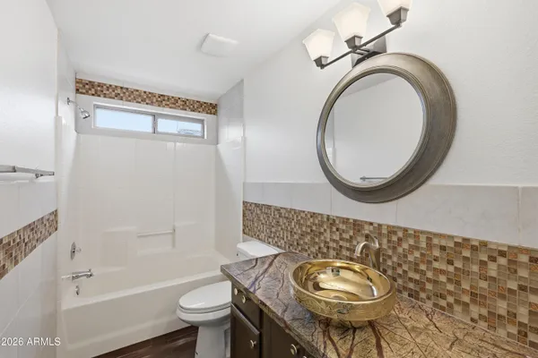 a bathroom with a toilet a sink and a mirror