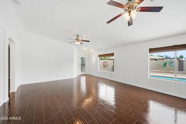 wooden floor in an empty room with a window