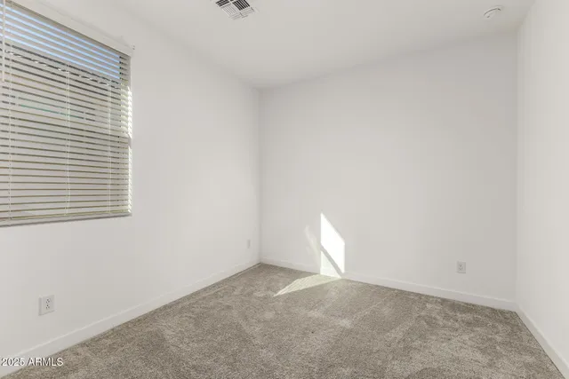 an empty room with closet and a bathroom