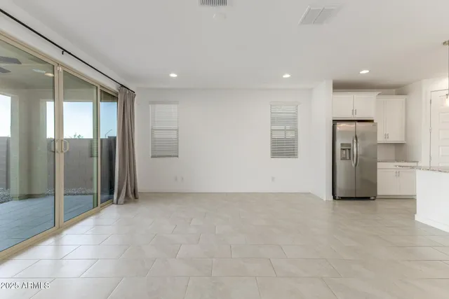 a view of an empty room with a kitchen