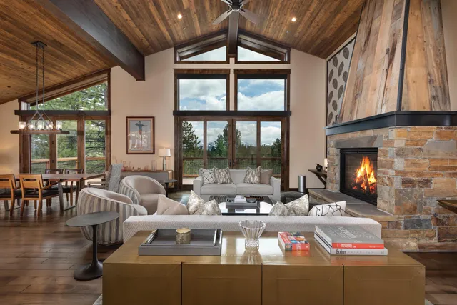 a living room with furniture fireplace and a floor to ceiling window