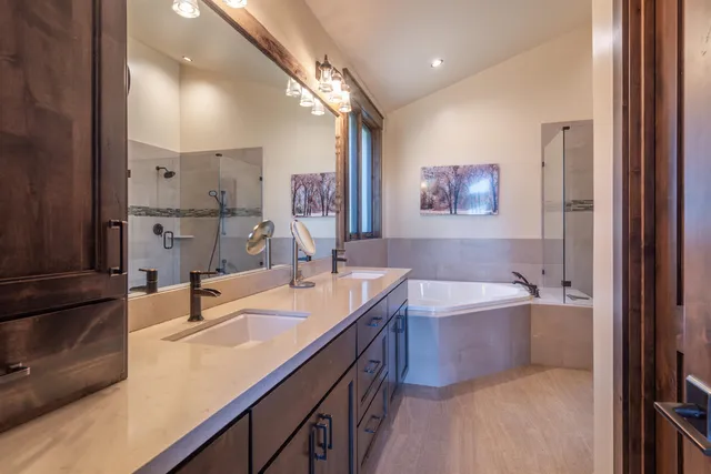 a bathroom with a tub sink and mirror