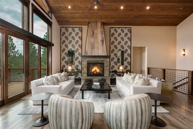 a living room with furniture a fireplace and a large window