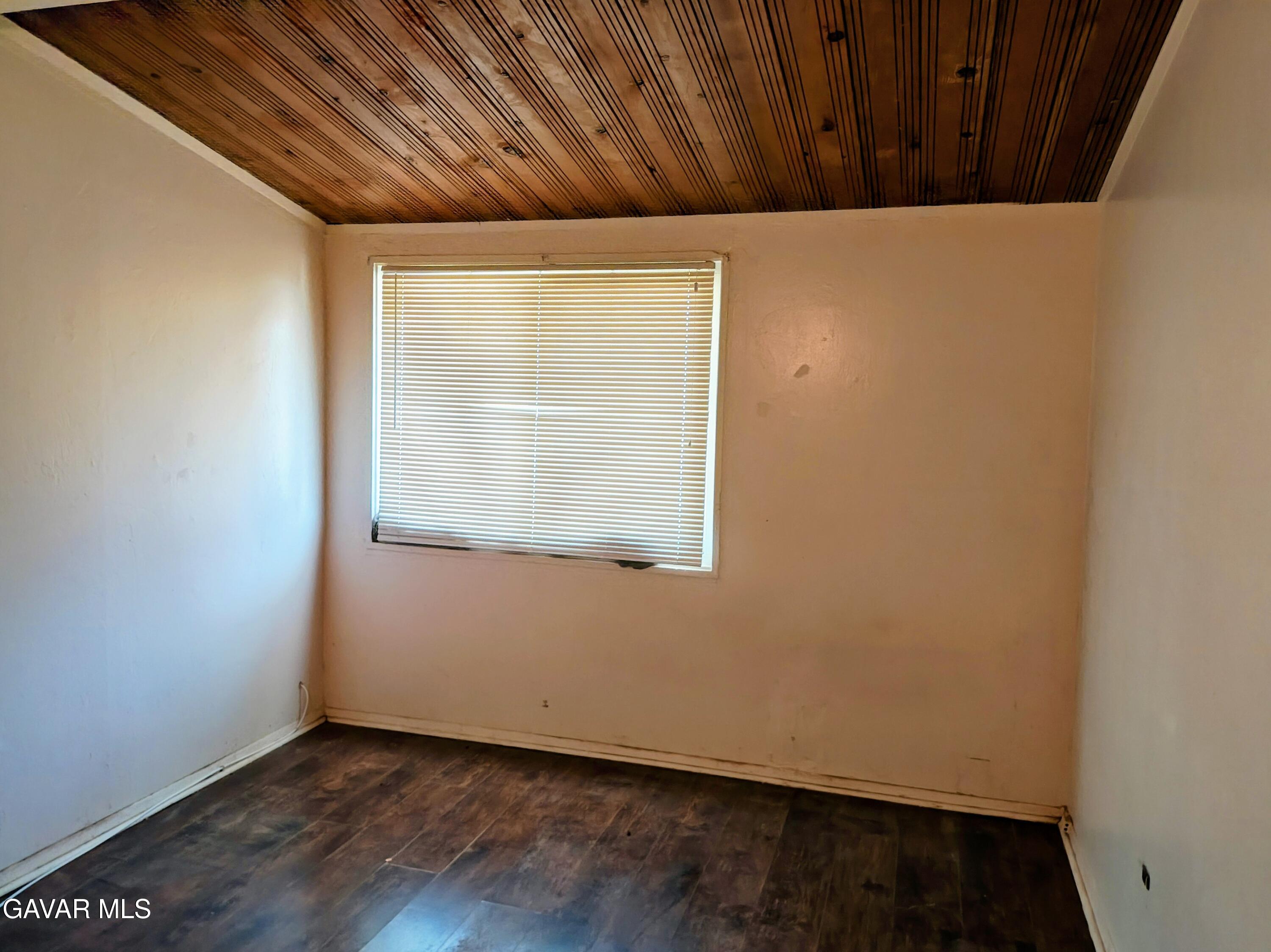 45446 10th Street West Lancaster, CA 93534 - Photo 11 of 17 a view of an empty room with wooden floor and a window
