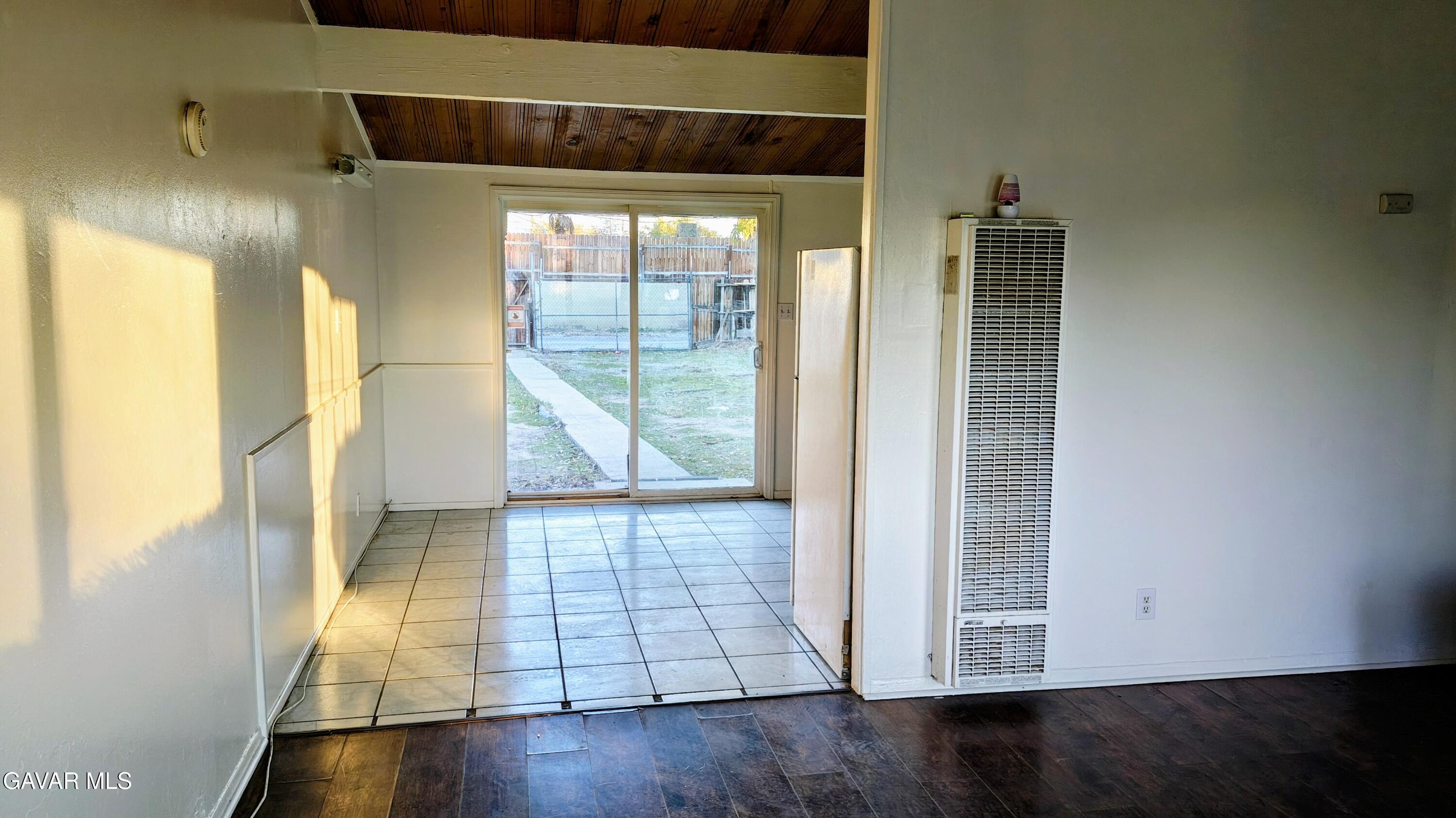 45446 10th Street West Lancaster, CA 93534 - Photo 2 of 17 a view of an empty room with wooden floor and a window