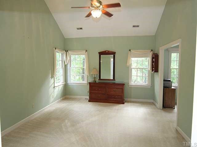 9000 Enfield Court Raleigh, NC 27615 - Photo 9 of 18 The large master bedroom opens to a sitting room/office with closet. A vaulted ceiling with fan and lots of light makes this room feel cozy, but very spacious. Master Suite