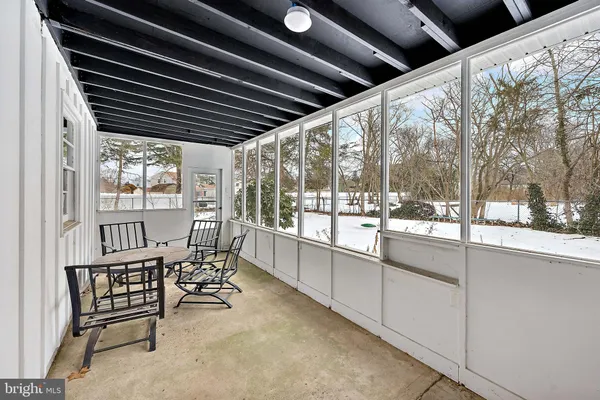 a view of a porch with furniture and wooden deck