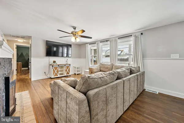 a living room with furniture fireplace and a flat screen tv