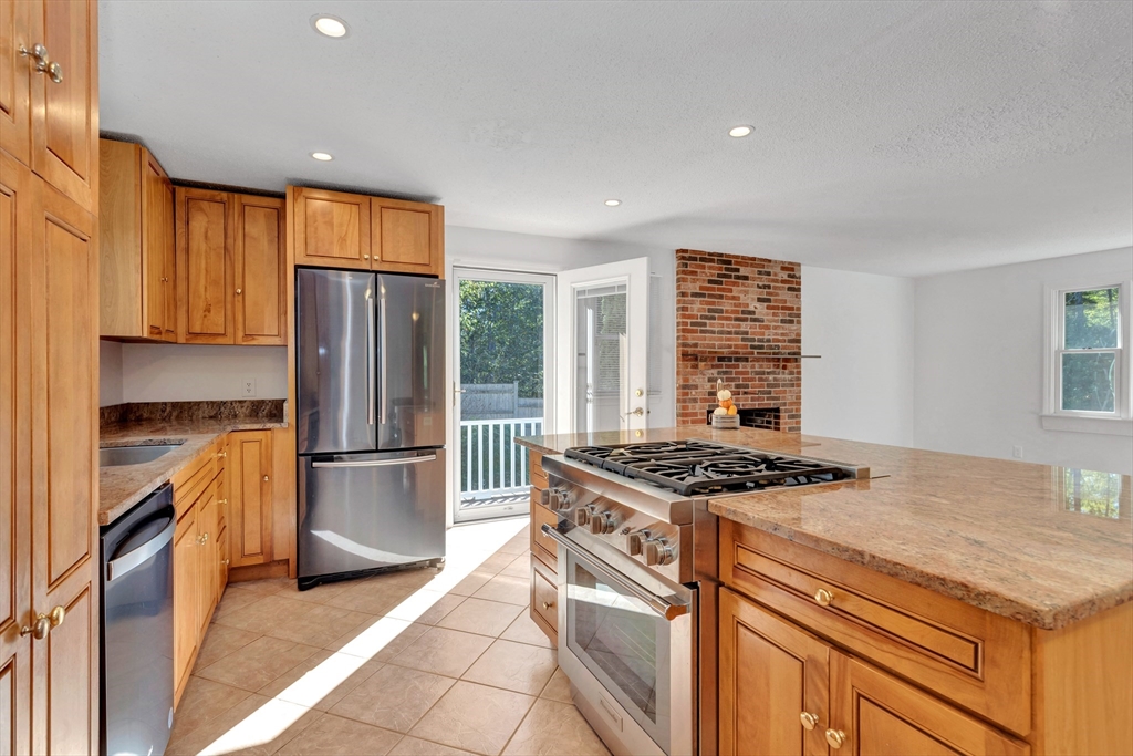 50 Laurel Street Gloucester, MA 01930 - Photo 13 of 40 a kitchen with a stove a refrigerator and a sink