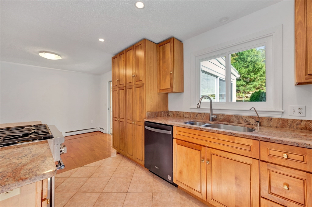50 Laurel Street Gloucester, MA 01930 - Photo 14 of 40 a kitchen with stainless steel appliances granite countertop a sink stove and refrigerator
