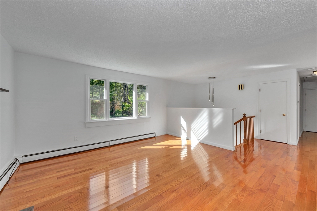 50 Laurel Street Gloucester, MA 01930 - Photo 16 of 40 a view of an empty room with wooden floor and a window