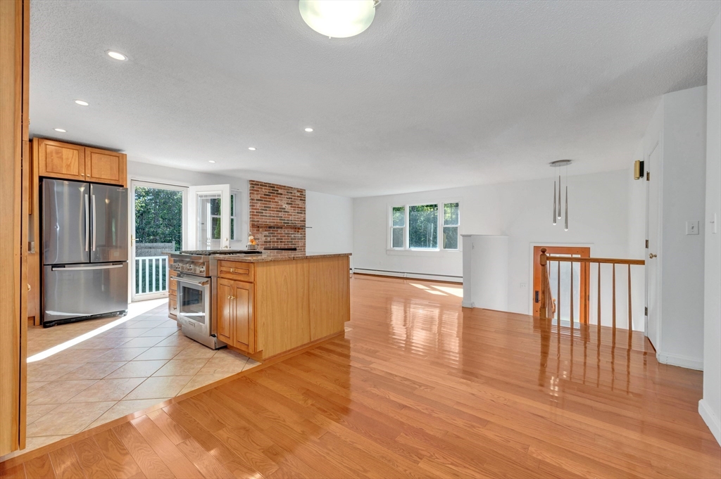 50 Laurel Street Gloucester, MA 01930 - Photo 18 of 40 a living room with stainless steel appliances wooden floor and large window
