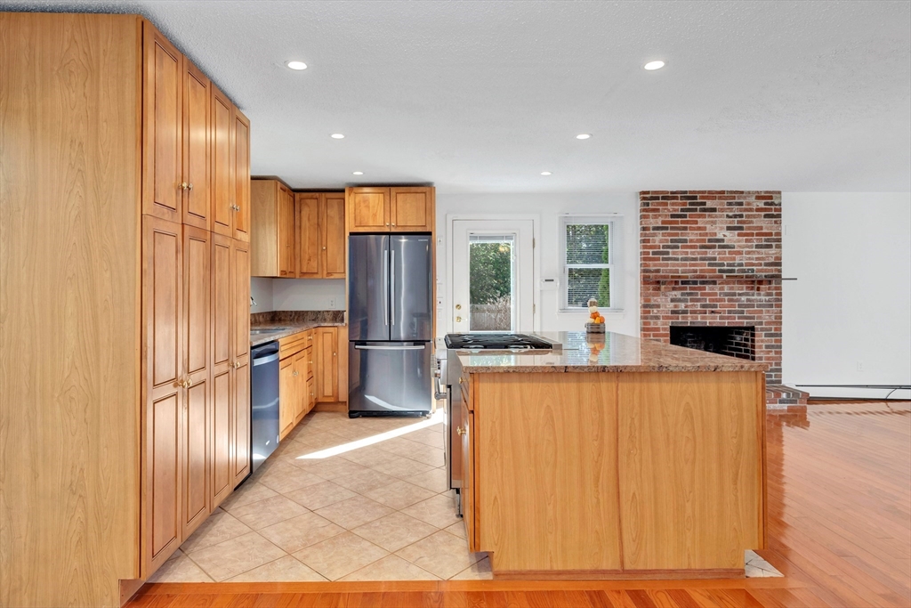 50 Laurel Street Gloucester, MA 01930 - Photo 19 of 40 a kitchen with stainless steel appliances a refrigerator and a stove top oven