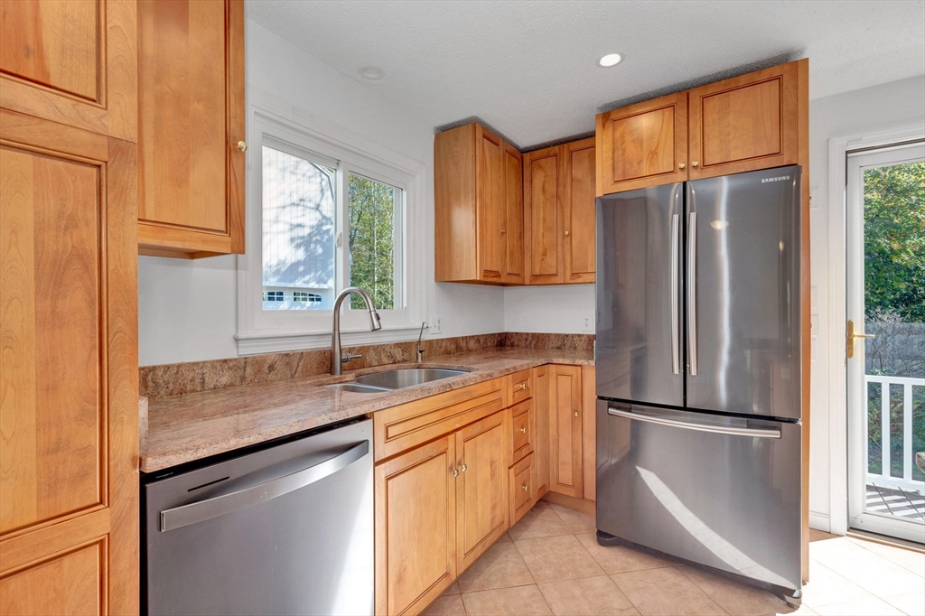 50 Laurel Street Gloucester, MA 01930 - Photo 20 of 40 a kitchen with stainless steel appliances granite countertop a refrigerator a sink and a cabinets