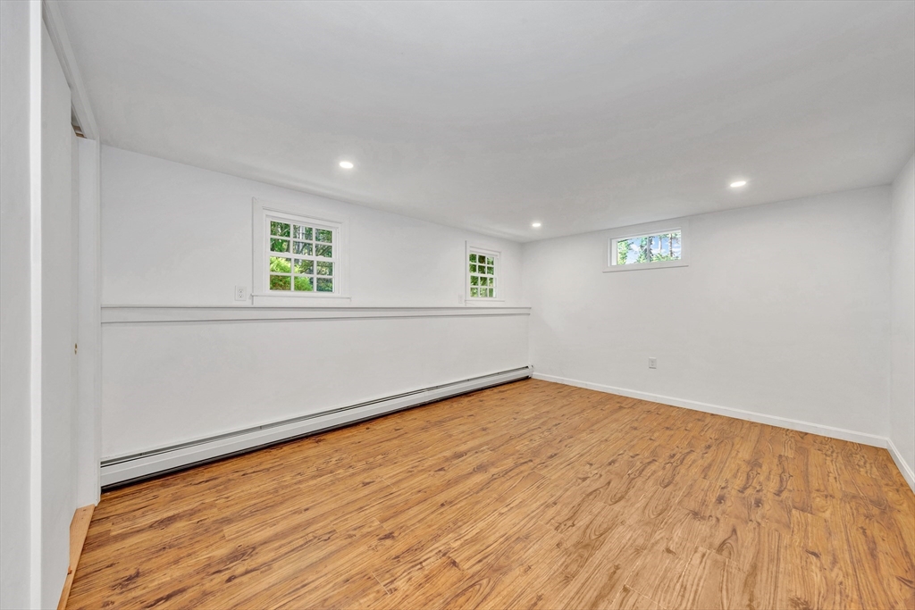 50 Laurel Street Gloucester, MA 01930 - Photo 30 of 40 an empty room with wooden floor and windows