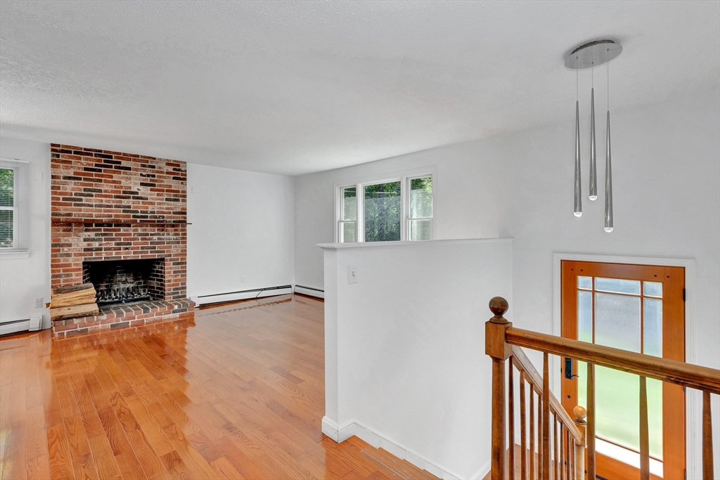50 Laurel Street Gloucester, MA 01930 - Photo 7 of 40 a view of empty room with fireplace and wooden floor