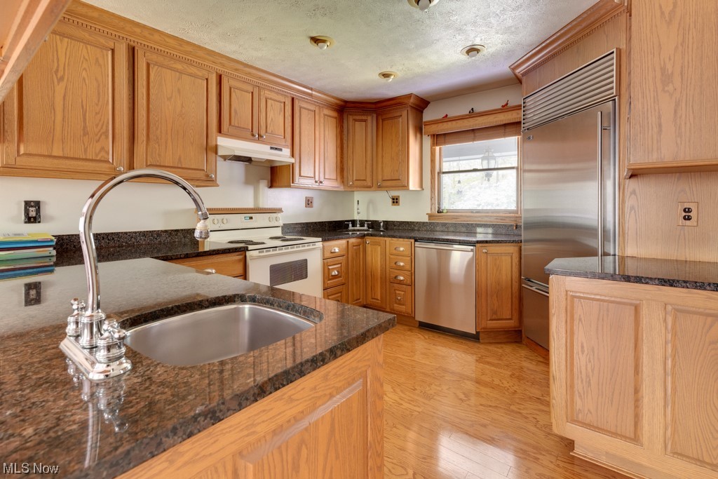 4616 Alliance Road Ravenna, OH 44266 - Photo 8 of 28 Kitchen featuring dark stone countertops, appliances with stainless steel finishes, and wood cabinets