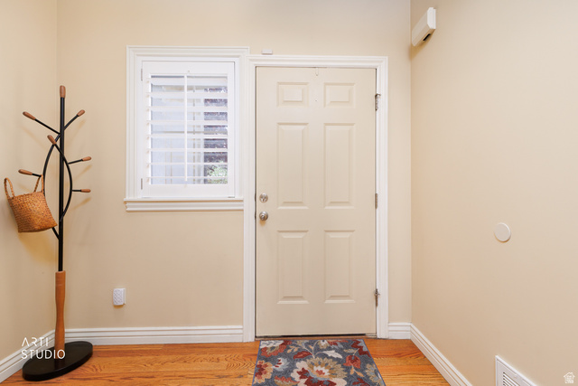 6761 950 East Midvale, UT 84047 - Photo 4 of 44 Entryway featuring a paneled door, wood-finish flooring, and a window with plantation shutters