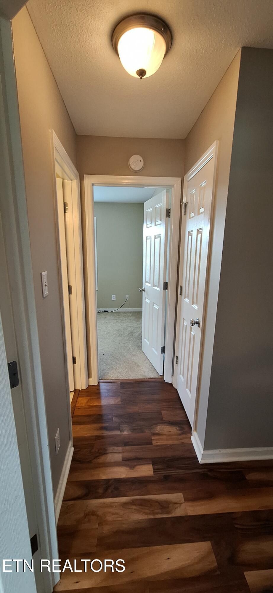 6199 Sinking Creek Road Greenback, TN 37742 - Photo 16 of 33 a view of a hallway view with wooden floor and staircase