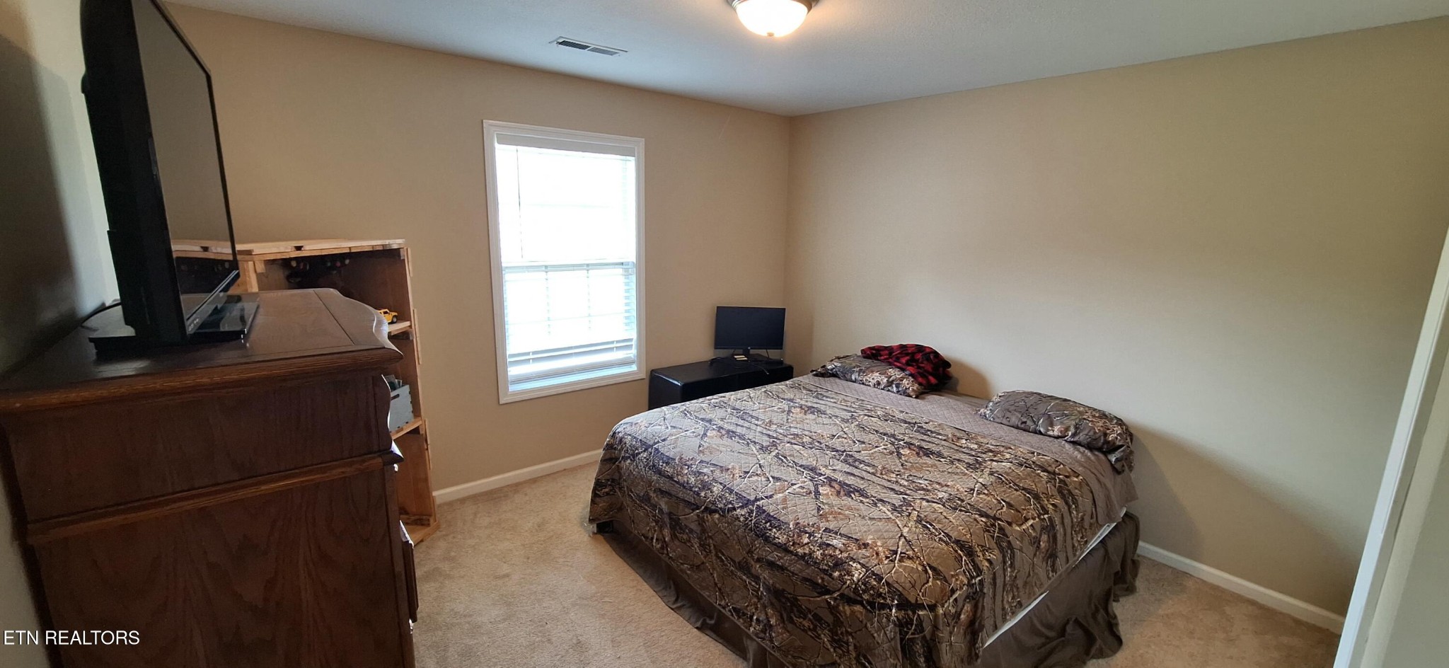 6199 Sinking Creek Road Greenback, TN 37742 - Photo 17 of 33 a bedroom with a bed and a window