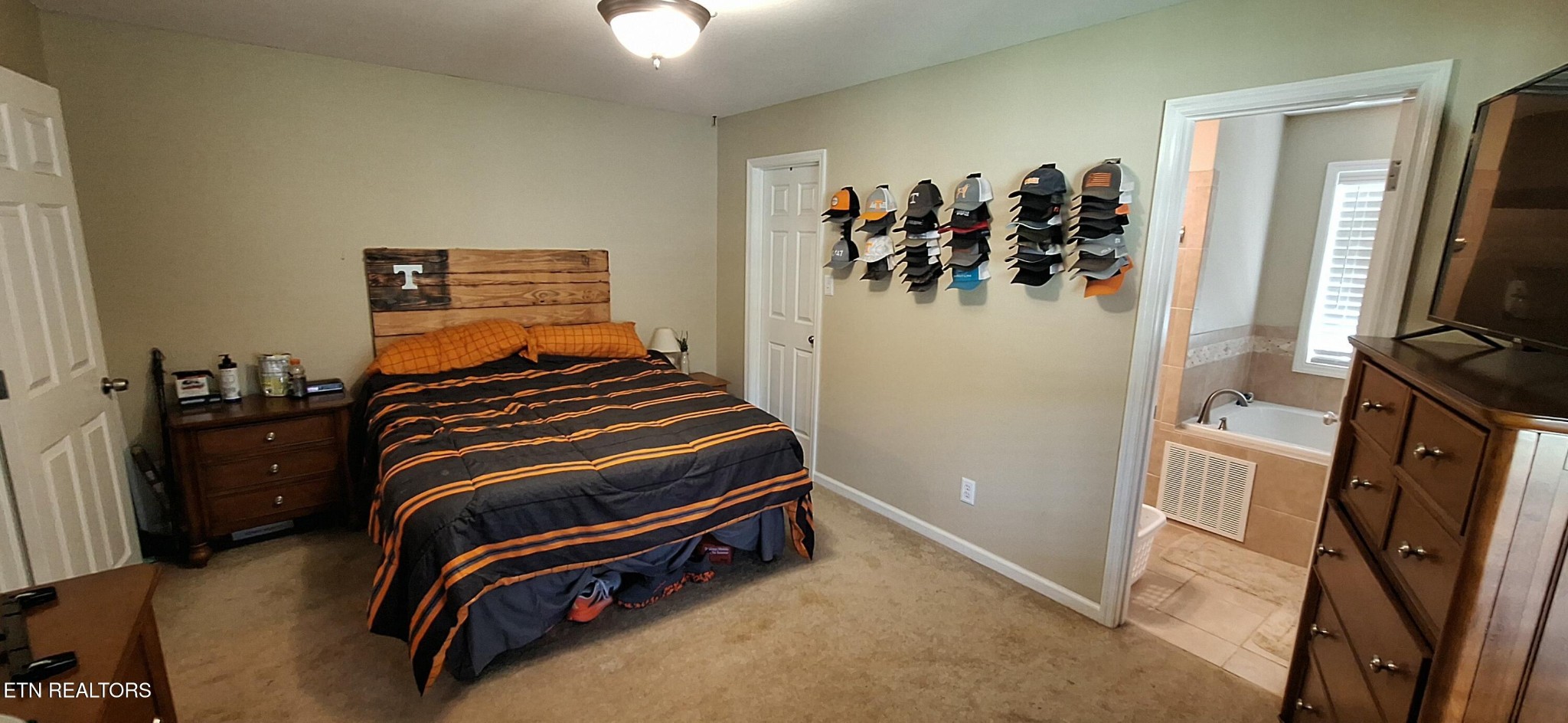6199 Sinking Creek Road Greenback, TN 37742 - Photo 26 of 33 a bedroom with a bed and a flat tv screen on the dresser