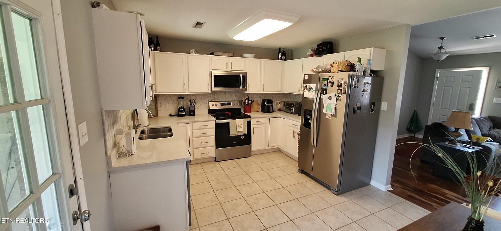 6199 Sinking Creek Road Greenback, TN 37742 - Photo 31 of 33 a kitchen with a refrigerator a stove top oven a sink and cabinets