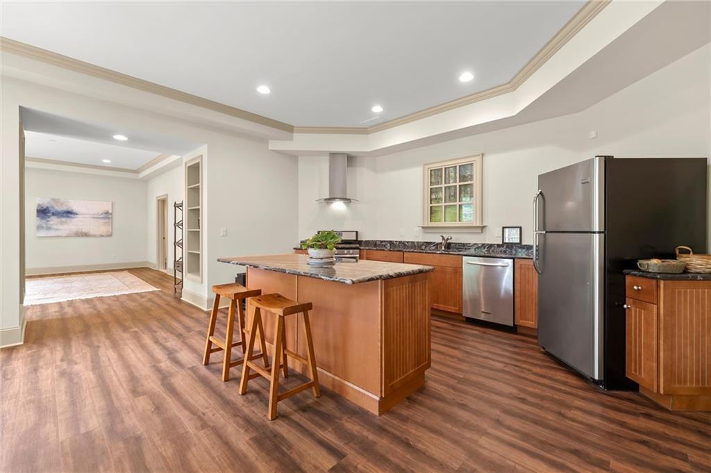 322 Edwards Brook Lane Canton, GA 30115 - Photo 85 of 99 a kitchen with stainless steel appliances granite countertop a refrigerator a sink dishwasher and a stove with wooden floor