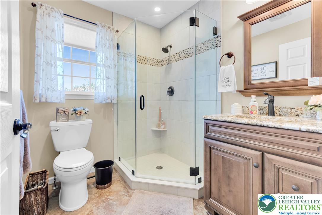 4059 Old Sentry Road Allentown, PA 18104 - Photo 11 of 39 Indulge in a tranquil bathing space, showcasing a spacious walk-in shower and elegant granite counters.