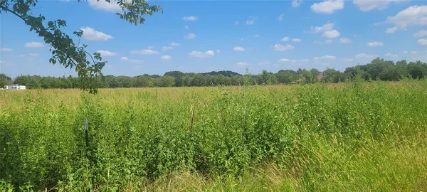 a view of lake with houses in the background