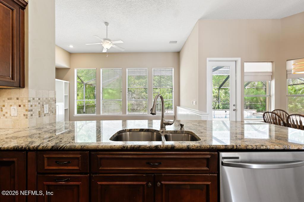 337 South Mill View Way Ponte Vedra Beach, FL 32082 - Photo 17 of 55 a kitchen with granite countertop a sink and a window