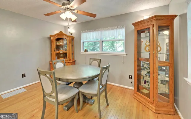 a dining room with furniture and window