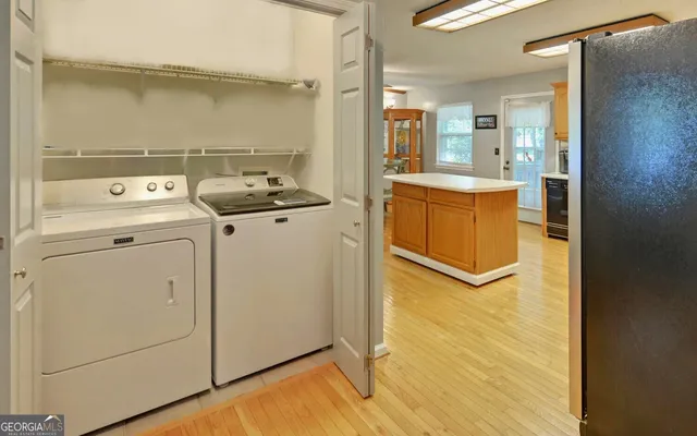 a view of washer and dryer with kitchen view