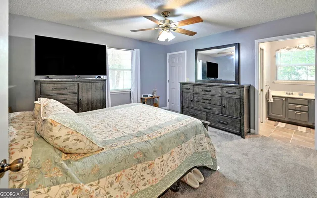 a bed room with a bed and a flat screen tv