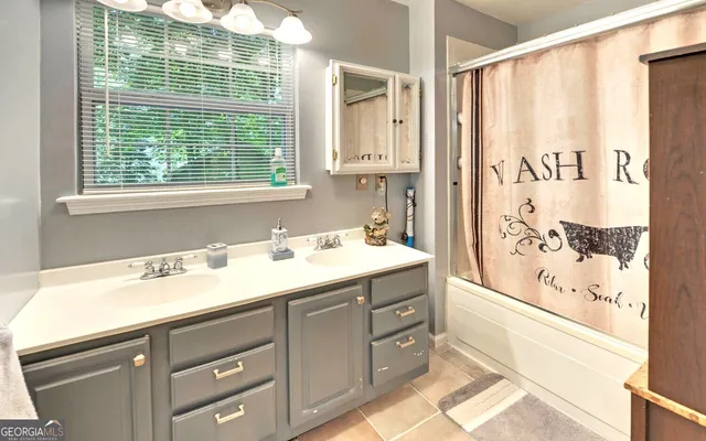 a bathroom with a sink a mirror and a shower
