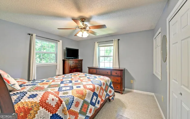 a bedroom with a large bed and a tv