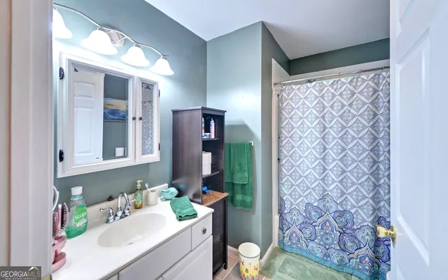 a bathroom with a sink vanity mirror and toilet
