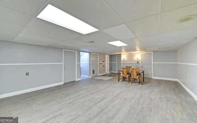 an empty room with furniture and natural light