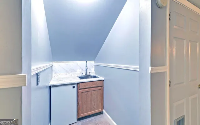 a en suite bathroom with a granite countertop sink and a mirror