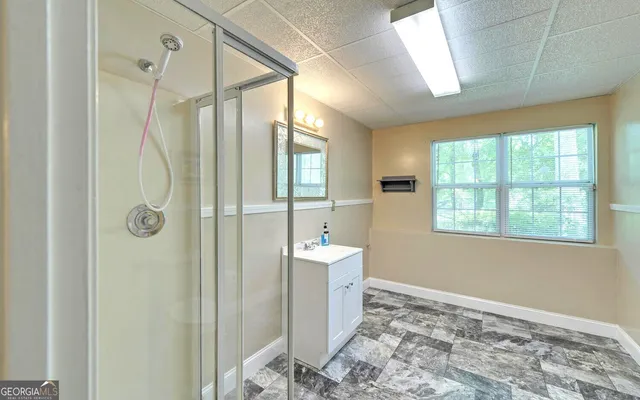 a bathroom with a shower and a sink