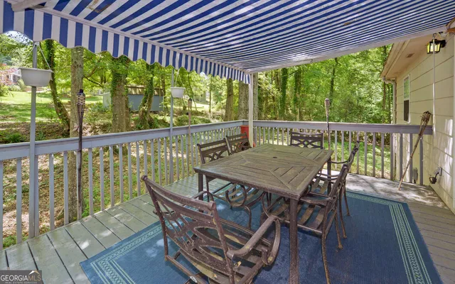 a view of a wooden chairs on the roof deck