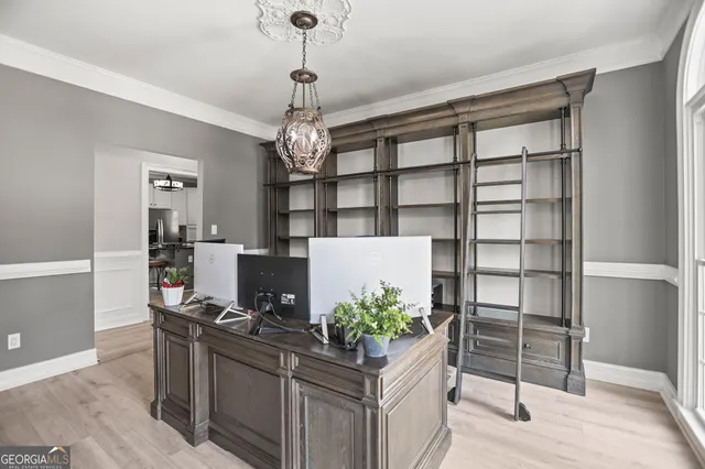 a view of an entryway with wooden floor windows and a livingroom