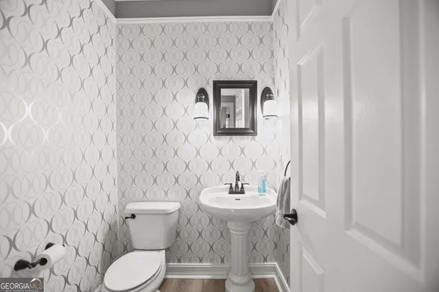 a view of a white house with a big yard and large trees