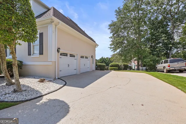 a view of a house with a small yard and floor to ceiling window