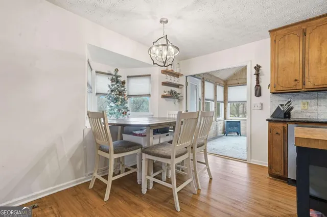 a view of a dining room with furniture window and wooden floor
