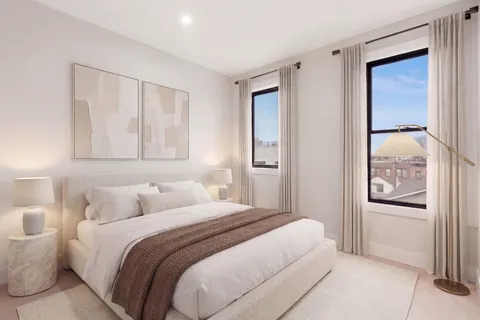 a bedroom with a bed and a mirror